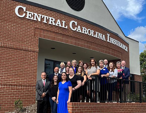 Staff of Central Carolina Insurance outside of office building