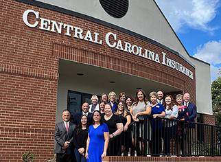 Central Carolina Insurance building with employees standing in front