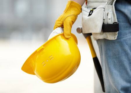 worker holding helmet with Contractors Insurance Coverage in Harrisburg, NC and Cornelius, NC