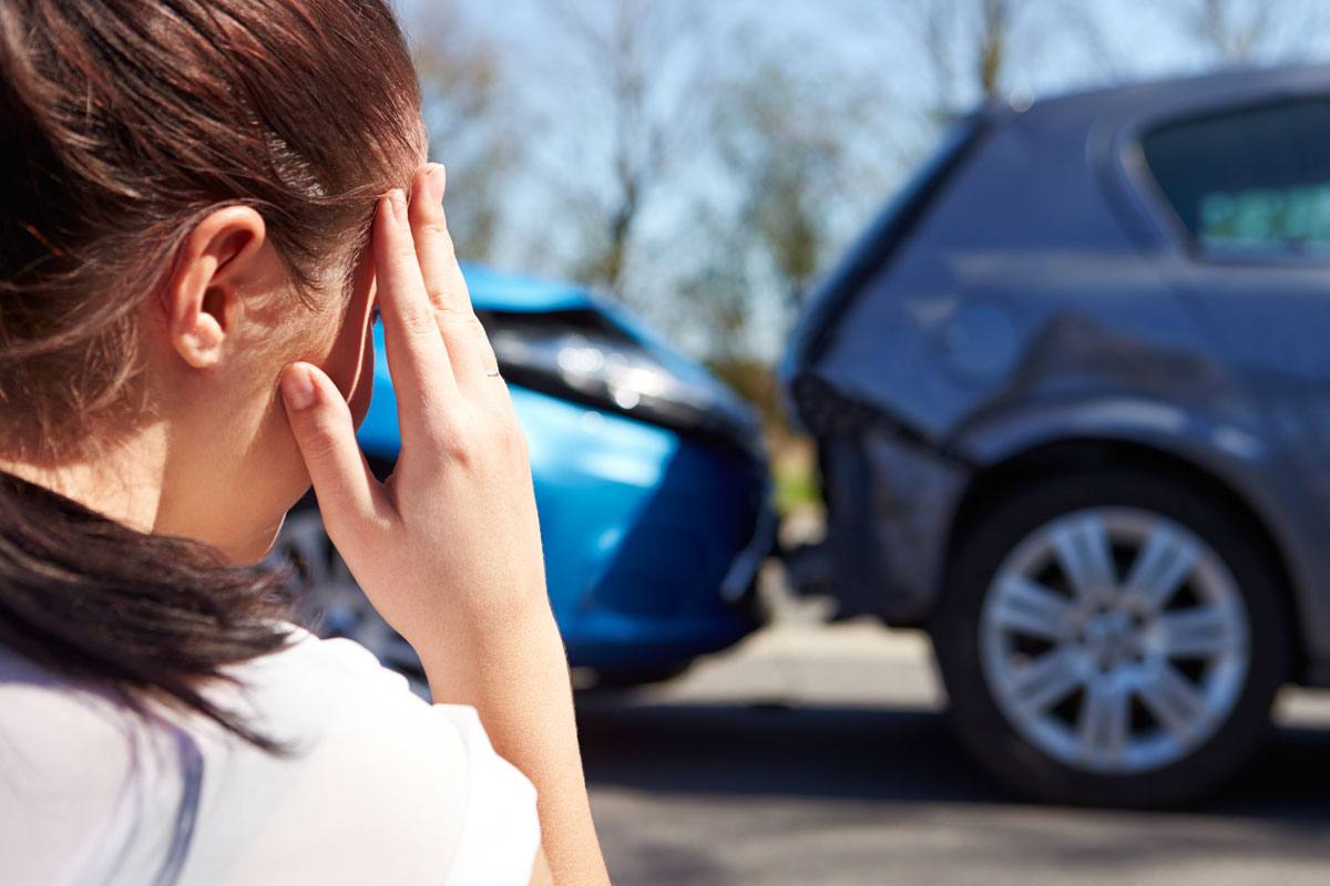 Woman near crashed cars needing Low-Cost Auto Insurance in Mount Pleasant, North Carolina