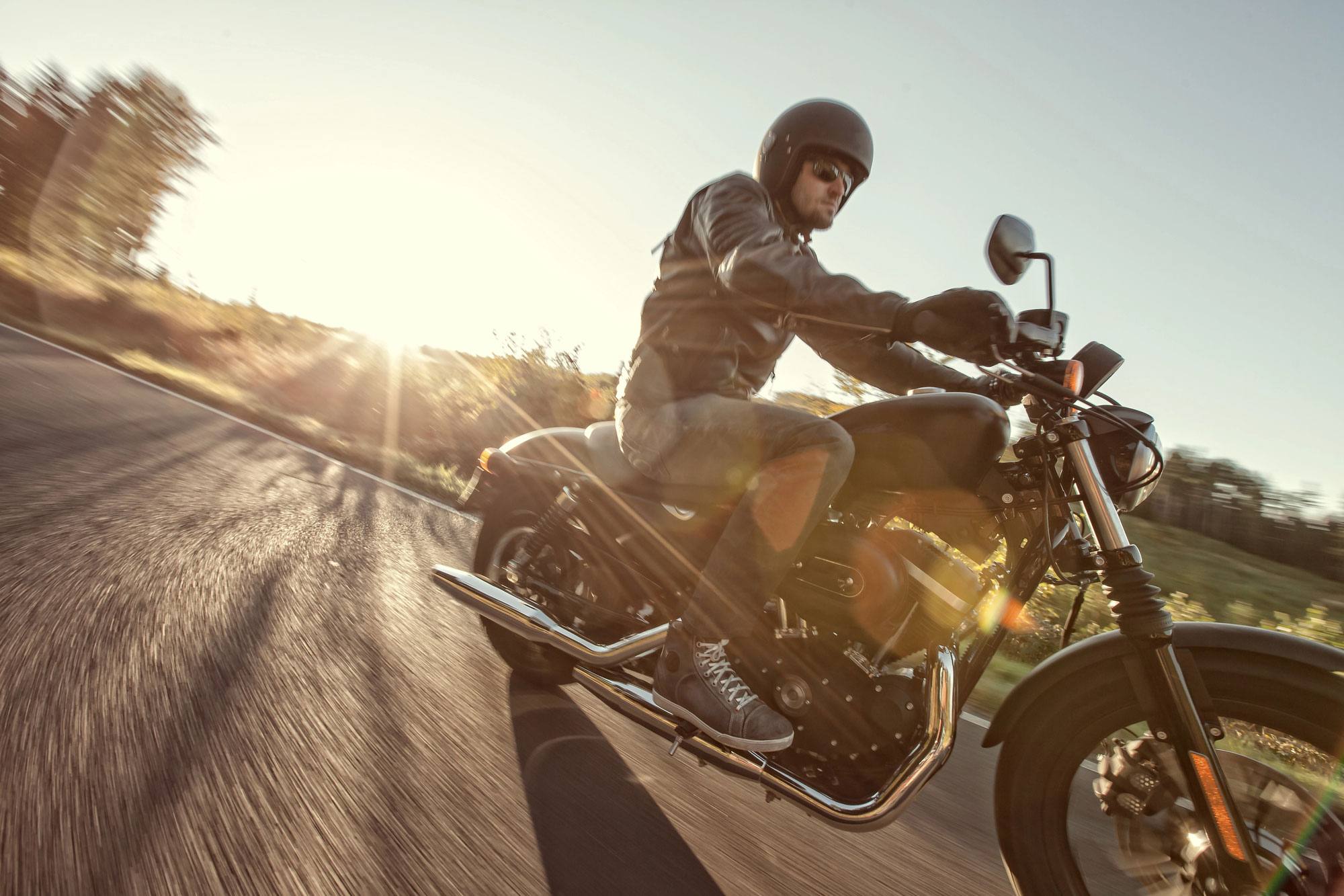 man driving motorcycle on road with Motorcycle Insurance In Salisbury, Concord, Mooresville, Kannapolis, Huntersville, Davidson, NC, and the Surrounding Areas