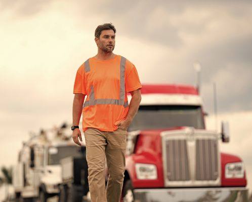 Driver in Concord, NC Walking in Front of Truck with Dump Truck Insurance
