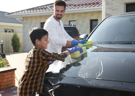 Family with a House and Car Insurance Bundle Washing a Car Outside Their Home in Salisbury, NC